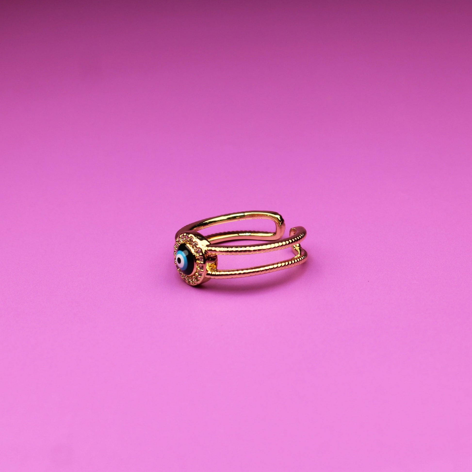 Gold ring on a pink background