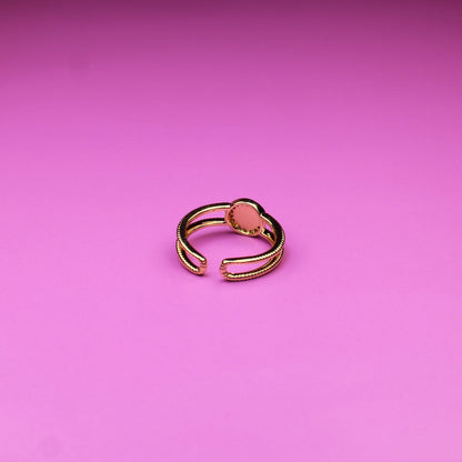 Gold ring on a pink background