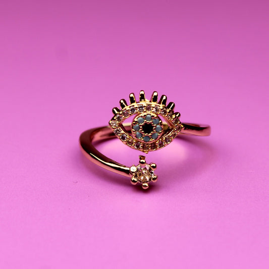 Rose gold ring with gemstones on a pink background