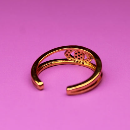 Gold bracelet on a pink background