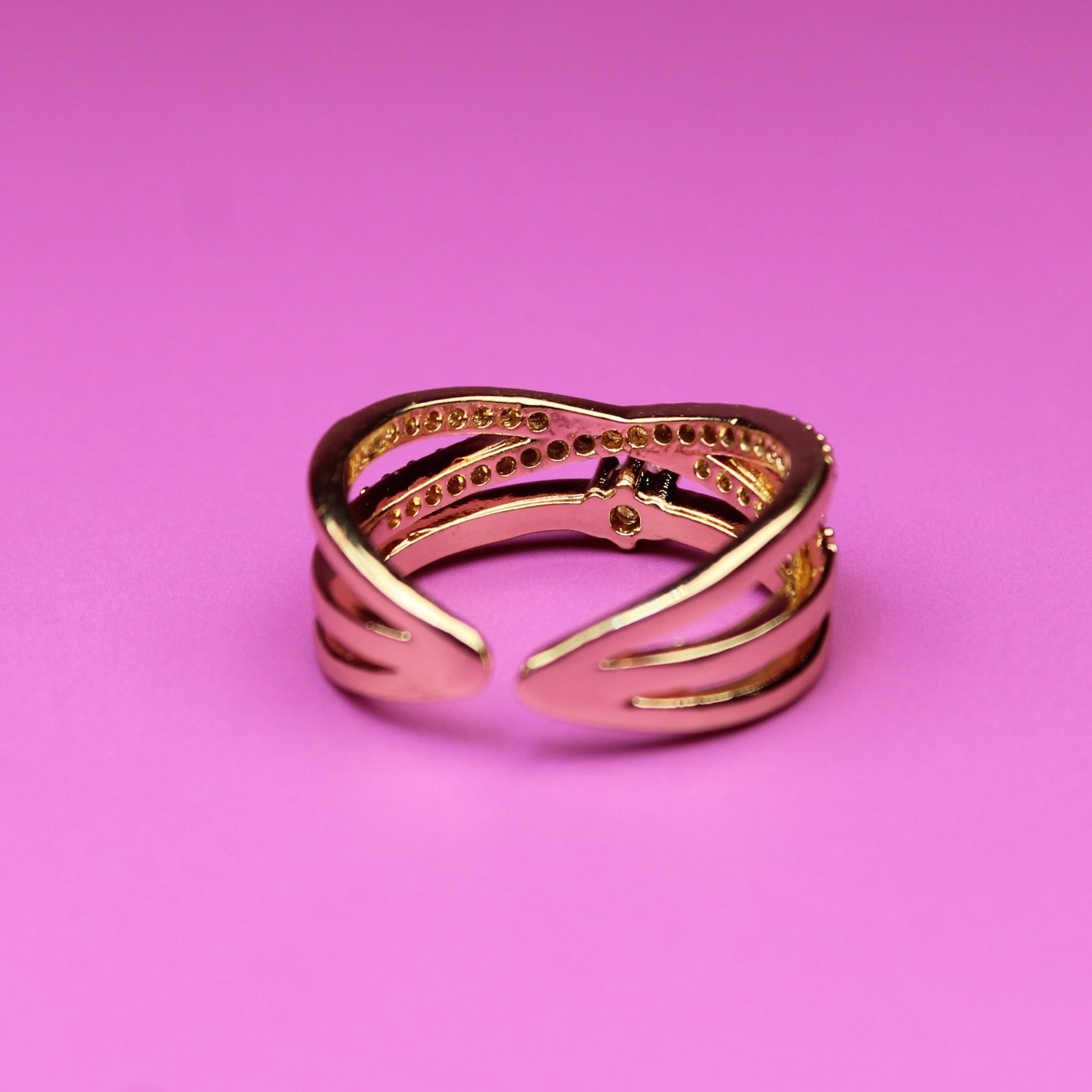Gold ring on a pink background
