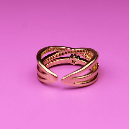Gold ring on a pink background