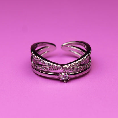 Silver ring with gemstones on a pink background
