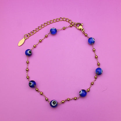 Bracelet with blue beads on a pink background