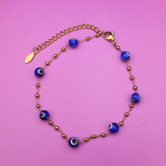 Bracelet with blue beads on a pink background