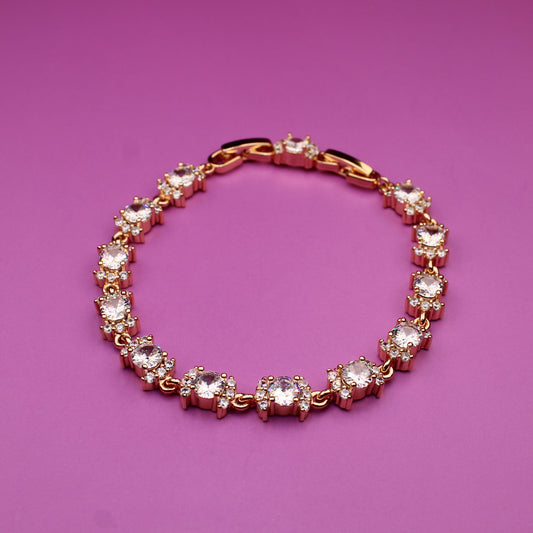 Gold bracelet with crystals on a purple background