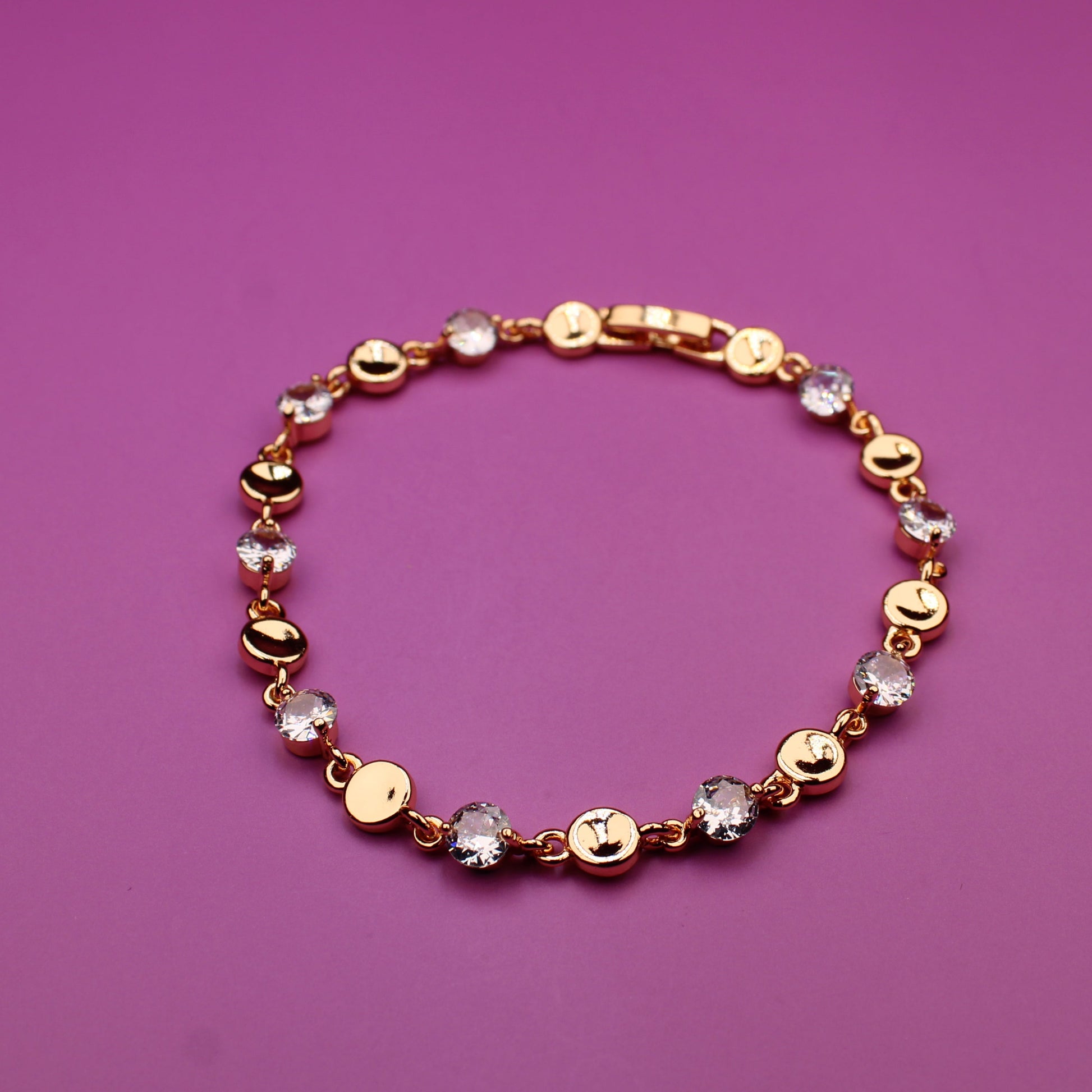 Bracelet with gold and multicolored beads on a purple background