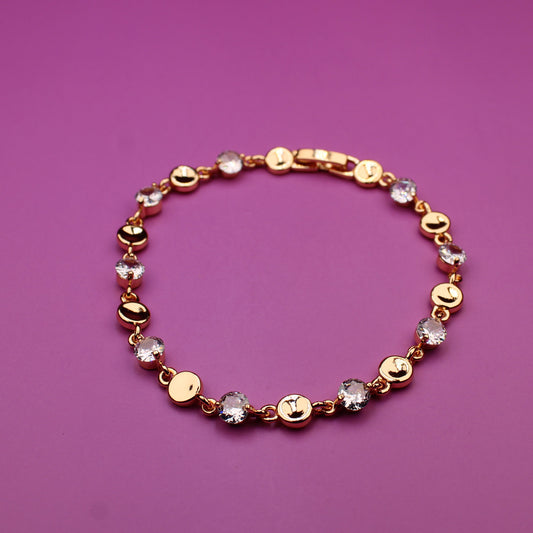 Bracelet with gold and multicolored beads on a purple background