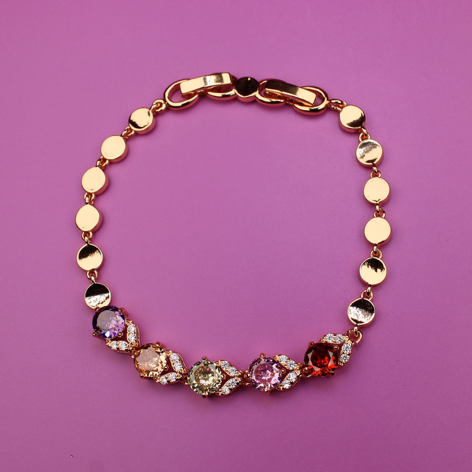 Bracelet with colorful beads on a pink background