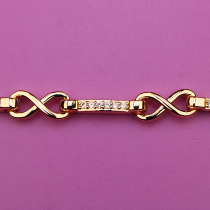 Gold bracelet with diamond accents on a purple background