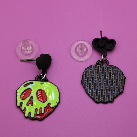 Two unique earrings on a pink background