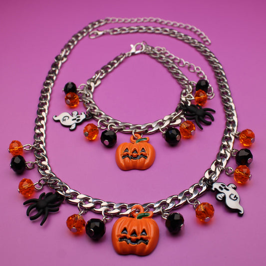 Necklace with Halloween-themed charms on a pink background