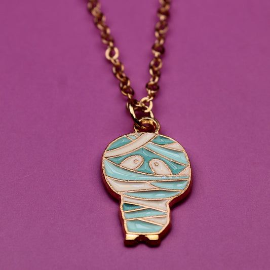 Necklace with a mummy-shaped pendant on a purple background