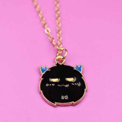 Necklace with a black cat pendant on a pink background