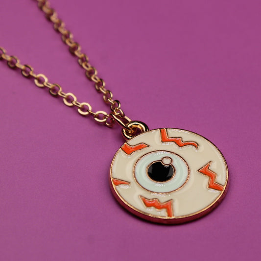 Necklace with an eye-shaped pendant on a purple background
