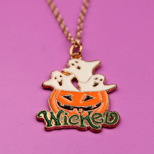 Halloween-themed necklace with pumpkin, ghost, and 'Wicked' text on a pink background
