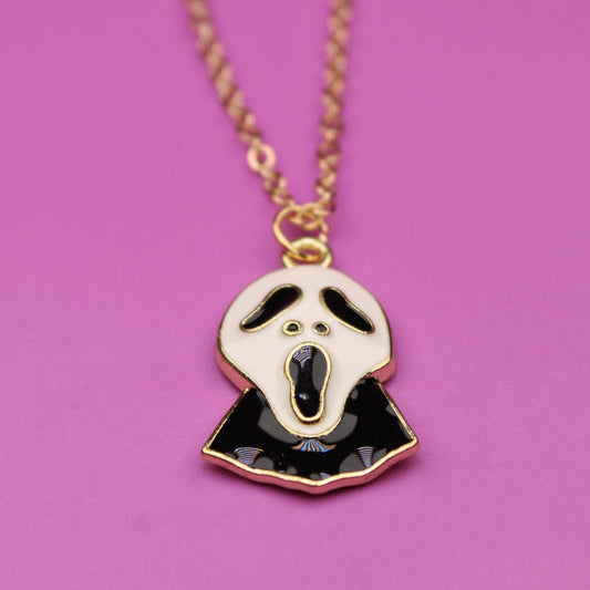 Necklace with a ghost pendant on a pink background