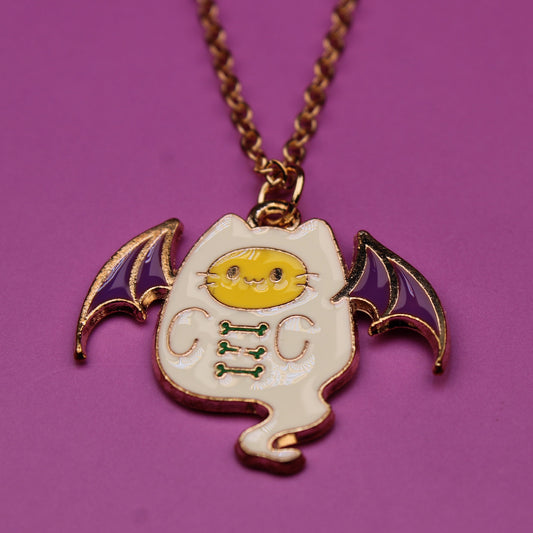 Bat-shaped pendant necklace on a purple background