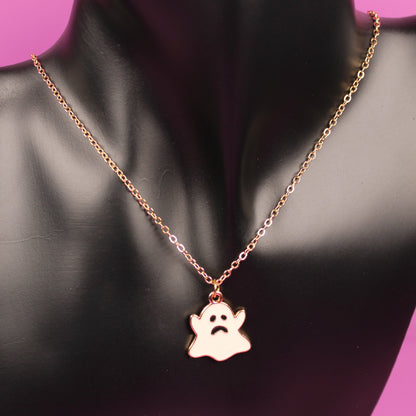 Necklace with a paw print pendant on a black mannequin bust against a pink background