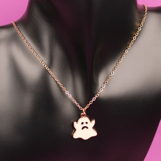 Necklace with a paw print pendant on a black mannequin bust against a pink background