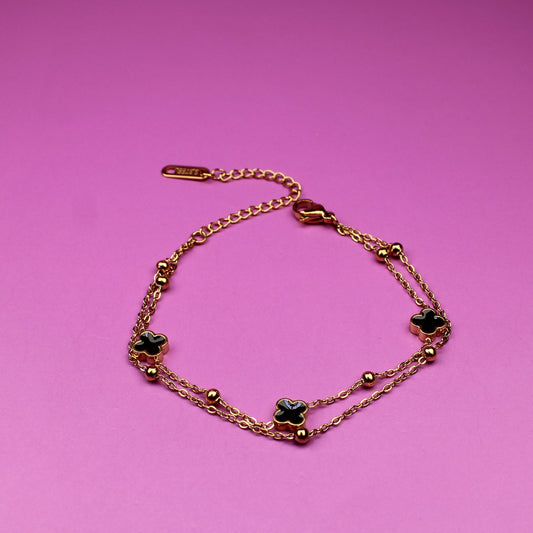Bracelet with green stones on a pink background